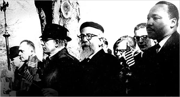 Rabbi Abraham J. Heschel, Professor of Mystecism and Theology at the Jewish Theological Seminary. marches arm-in-arm with Dr. Martin Luther King, Jr. at the Selma-Montgomery March